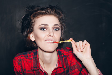 Obraz premium Young sexy girl eating gelatin candy. Outdoors, lifestyle.