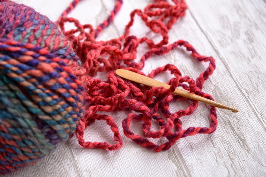 Ball Of Purple Yarn And Crochet Hook