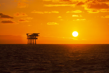 Oil platform at sunset