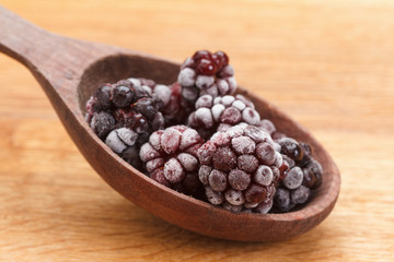 Macro view on frozen Blackberry fruits in spoon