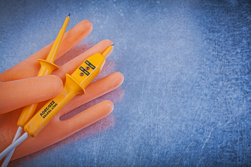 Obraz premium Dielectric rubber gloves electrical tester on metallic backgroun
