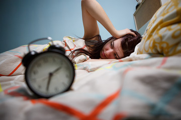 Woman with insomnia touching her head
