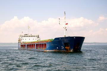 The ship bulk carrier at anchor in front of the entrance to the Port of Gdansk