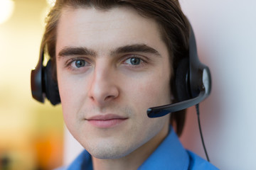 Young call center agent speaking with costumer