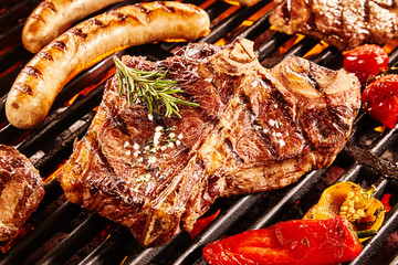 Gourmet barbecue t-bone steak  grilling over the fire