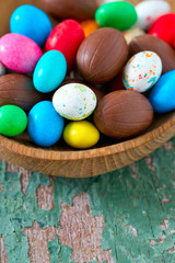 Easter candy eggs on old wooden surface