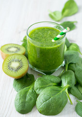 fresh green smoothie on wooden surface