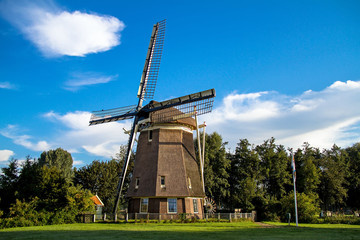 Fototapeta na wymiar Traditional dutch windmill near the lake in Amsterdam,Netherlands 