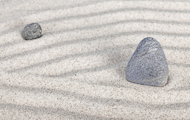 Two stones in sand, nature and harmony concept
