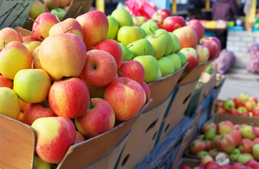 Delicious colorful apples in the boxes on the market