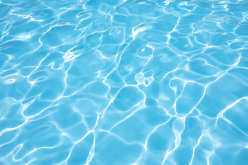 Fototapeta na wymiar Beautiful blue water in swimming pool with sun reflection