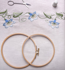 Handemade embroidery. The cloth, thread, thimble, scissors, embroidery hoop