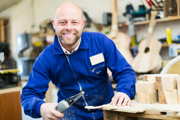 Woodworker on lathe in workroom