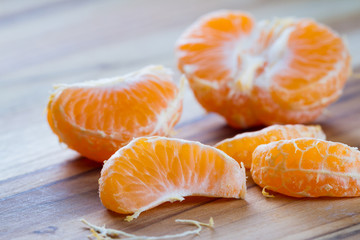 peeled orange on a cutting board