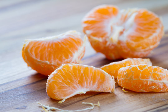 peeled orange on a cutting board
