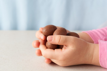 Child's hands holding chocolate Easter eggs