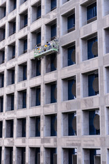 Group of Workers Cleaning Windows Service on High Rise Building.