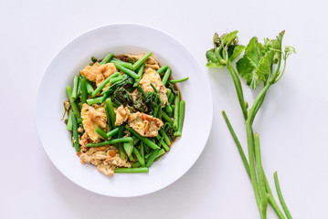 Fried green vegetable with egg.