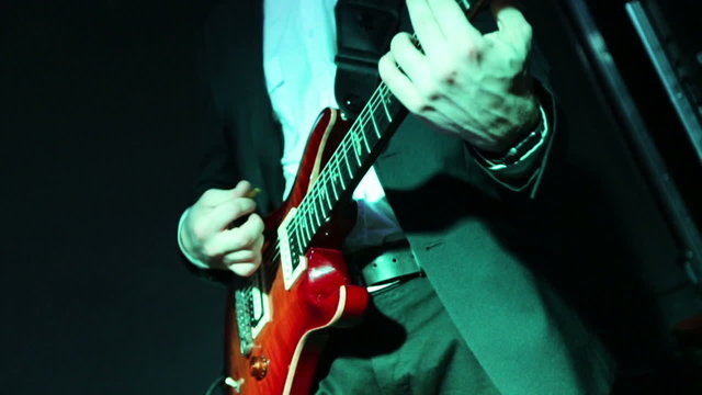 Young talented musician playing electrical guitare in a private party.