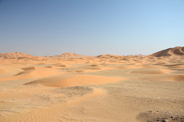 Sand dune field under blue sky sahara