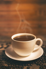 warm cup of coffee on brown background