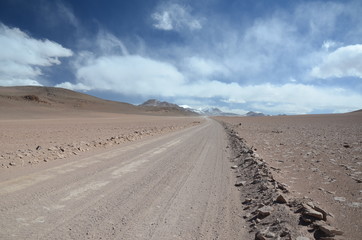 Fototapeta na wymiar Dramatic Sky and dirt track in the desert