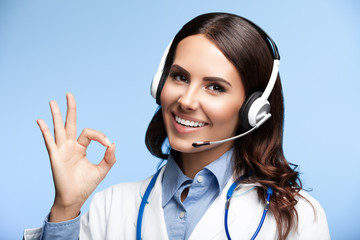 happy smiling doctor in headset, on blue