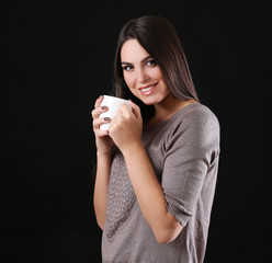 Portrait of smiling pretty woman with cup of coffee