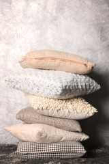 Few pillows on grey wall background