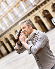 Man taking pictures on travel journey