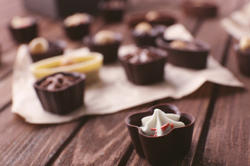 Chocolate sweets on wooden background