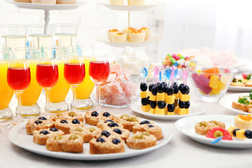 Set of cold snacks, canape, beverages, closeup