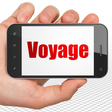 Travel concept: Hand Holding Smartphone with Voyage on display