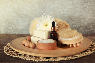 Fototapeta na wymiar Variety of natural bath tools on wooden table, on grey wall background