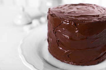 Tasty chocolate cake on light background