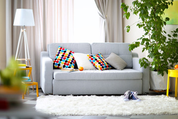 Living room interior with sofa, lamp and green tree