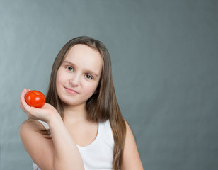 Girl with tomatoes in her hand