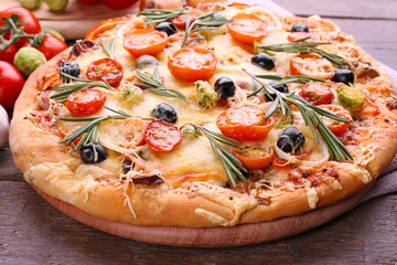 Delicious fresh pizza on wooden table closeup
