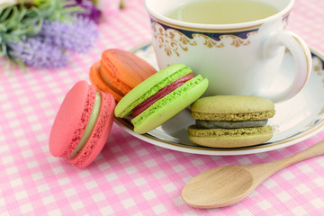Cup of tea with colorful macaroons