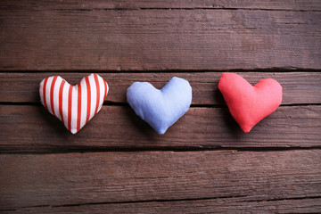 Small hearts on wooden background