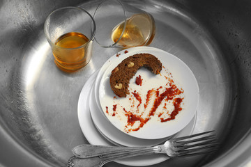 Dirty kitchenware in kitchen sink closeup