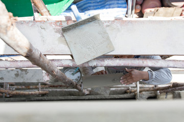 Plasterer cement concrete man worker stand on scaffold woodl plastering wall of residential construction house