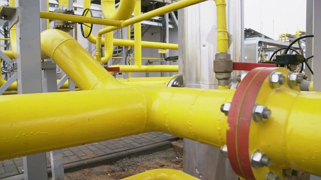 yellow pipe on gas plant. shot with slider