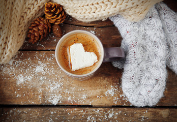 Cup of coffee with marshmallow on wooden table