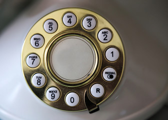 Golden dial plate of a vintage phone