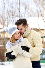 Young couple embracing outdoors in winter