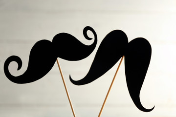 Black mustache on wooden stick, closeup