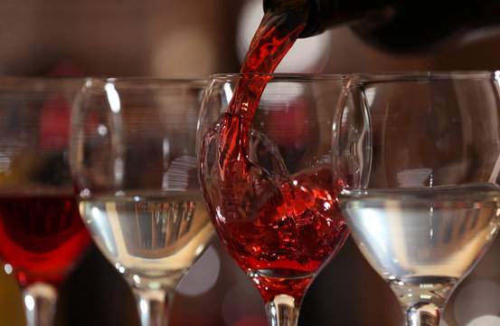 Red wine pouring into wine glass, closeup