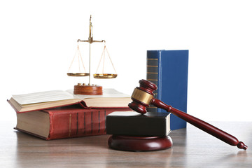 Wooden gavel with justice scales and books on white background