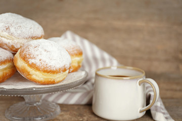 Delicious sugary donuts on wooden table closeup
